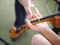 Close up hands of student and teacher on violin lesson