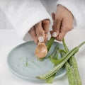 Close up hands taking aloe vera gel. High quality and resolution beautiful photo concept Royalty Free Stock Photo