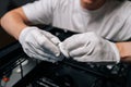 Close-up hands of technician male cleaning computer processor with white cloth, preparing for installation in computer Royalty Free Stock Photo