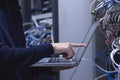 Close up of hands technician working on laptop in data center