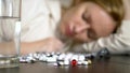 Close up of hands touching pills. The concept of health care, vitamin deficiency. woman sorts pills sitting at the table