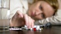 Close up of hands touching pills. The concept of health care, vitamin deficiency. woman sorts pills sitting at the table