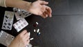 View from above. Close up of hands touching pills. The concept of health care, vitamin deficiency. woman sorts pills