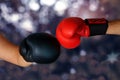 Close-up hands of two boxers in red and black boxing gloves closed for sports greeting on dark background with space for copy text Royalty Free Stock Photo