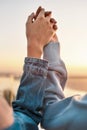 Close up of hands of two women watching the sunrise together. Young lesbian couple having romantic moment outdoors Royalty Free Stock Photo