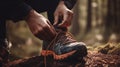 Close-up of hands tying shoelaces on trail running shoes
