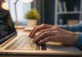 Close up of hands typing code on a laptop in a dimly lit room Royalty Free Stock Photo