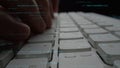Close-up of Hands Typing on a Computer Keyboard with Abstract Programming Code and Data Overlay for Technology and Royalty Free Stock Photo