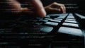 Close-Up of Hands Typing on Computer Keyboard Surrounded by Lines of Code in Dark Environment Enhancing Technology and Royalty Free Stock Photo