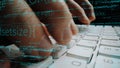 Close-Up of Hands Typing on Keyboard with Code Overlay Illustrating Software Development and Programming Concepts in Royalty Free Stock Photo