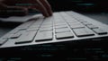 Close-up of Hands Typing on a Keyboard with Coding Symbols in the Background, Representing Programming, Technology, and Royalty Free Stock Photo