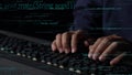 Close-up of Hands Typing on Keyboard with Lines of Code and Programming Elements in Dark Room, Symbolizing Software Royalty Free Stock Photo
