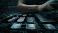 Close-up of Hands Typing on Keyboard Overlaid with Code and Digital Elements in a Dark Environment, Representing Royalty Free Stock Photo