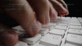 Close-Up of Hands Typing on a Keyboard with Programming Code Overlay Showing Software Development and Technology Royalty Free Stock Photo