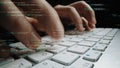Close-Up of Hands Typing on a Keyboard Surrounded by Coding Text and Data, Symbolizing Technology and Digital Royalty Free Stock Photo