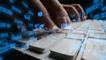 Hands Typing on a Keyboard with Digital Graphics Representing Data Analysis, Statistics, and Technology Concepts in a Royalty Free Stock Photo