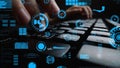 Close-Up of Hands Typing on Keyboard Surrounded by Futuristic Data Visualizations and Digital Interface Elements in a Royalty Free Stock Photo