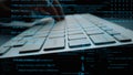 Close-up of Hands Typing on Keyboard Surrounded by Programming Code and Data Streams in a Modern Tech Environment for Royalty Free Stock Photo