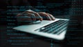 Close-Up of Hands Typing on Laptop with Code in Background and Digital Data Overlay for Technology and Programming Royalty Free Stock Photo