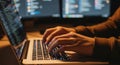Close-Up of Hands Typing on Laptop with Coding Screens in Background Royalty Free Stock Photo