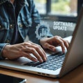 Person updating software on a laptop computer with digital overlay Royalty Free Stock Photo