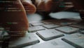 Close-up of hands typing on a laptop keyboard with digital code overlay creating a tech-inspired atmosphere for Royalty Free Stock Photo