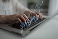 Close-up of Hands Typing on Laptop Keyboard with Digital Graphs and Data Analytics Emerging, Representing Growth and Royalty Free Stock Photo