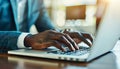 Close up of hands typing on laptop keyboard with open web browser for efficient work