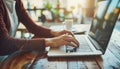 Close up of hands typing on laptop keyboard with an open web browser searching online Royalty Free Stock Photo