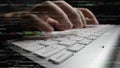 Close-Up of Hands Typing on a Laptop Keyboard Surrounded by Computer Code and Programming Scripts in a Dynamic Software Royalty Free Stock Photo
