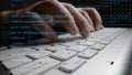 Close-Up of Hands Typing on a Laptop Keyboard Surrounded by Lines of Code and Digital Data Representations in a Modern Royalty Free Stock Photo