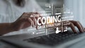 Close-up of Hands Typing on Laptop with Overlaid Coding Terminology and Concepts in a Modern Office Setting to Royalty Free Stock Photo
