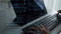 Close-Up of Hands Typing on a Laptop Surrounded by Digital Code and Programming Syntax in a Dark Setting xenic Royalty Free Stock Photo