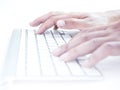 Hands typing on remote control wireless computer keyboard Royalty Free Stock Photo