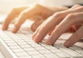 Close up of hands typing on a white computer keyboard Royalty Free Stock Photo