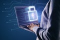 Close up of hands uding laptop with glowing security padlock on blurry background. Digital interface and protection, hacker Royalty Free Stock Photo