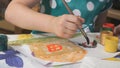 Unknown child drawing picture with watercolours