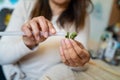 Close up on hands of unknown caucasian woman making decorative products at home leisure activity hobby arts and crafts