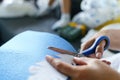 Close up on hands of unknown caucasian woman using scissors at home - Creative female cutting fabric adjusting pattern handmade Royalty Free Stock Photo