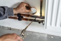 Close up on hands Unknown industrial worker plumber with central heating copper pipes welding using gas torch or blowtorch on the Royalty Free Stock Photo