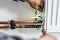 Close up on hands Unknown industrial worker plumber with central heating copper pipes welding using gas torch or blowtorch on the