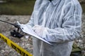 Close up on hands of unknown man crime scene detective inspector during investigation collecting evidence on the crime scene Royalty Free Stock Photo