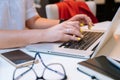 Close up of hands unrecognisable woman sitting in office coworking and typing on her laptop keyboard computer