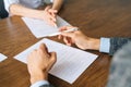 Close-up hands of unrecognizable businessman signing document holding pen, putting signature at official paper Royalty Free Stock Photo