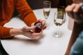 Close-up hands of unrecognizable loving young man making proposal for marriage to woman at table with candles, marry me. Royalty Free Stock Photo