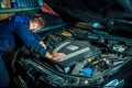 Close up hands of unrecognizable mechanic doing car service and maintenance. Mechanic working in car motor. Royalty Free Stock Photo