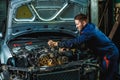 Close up hands of unrecognizable mechanic doing car service and maintenance. Royalty Free Stock Photo