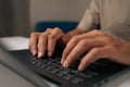 Close-up hands of unrecognizable programmer male typing code on laptop keyboard, showcasing process of software Royalty Free Stock Photo