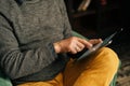 Close-up of hands of unrecognizable senior adult male browsing internet content using digital tablet