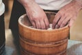 Close-up of hands of a unrecognizable sushi chef cooking rice in a traditional wooden Asian steamer basin Royalty Free Stock Photo